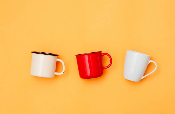Three cups of coffee on yellow background, Top view  - 写真・画像