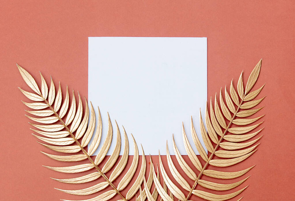 Golden palm branches and sqaure board on pink background. - Foto, Imagen