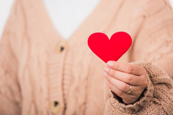 Love Valentine's Day. Female beauty hands holding modern a red heart isolated on white background, giving help donation medical healthcare happy holiday background concept - Foto, Bild