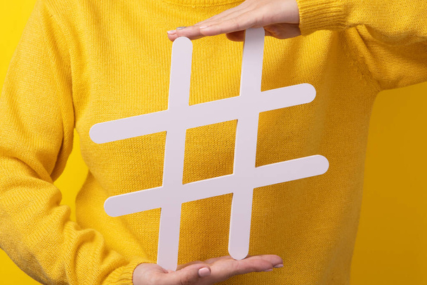 Beliebte Blog-Posts, trendige Inhalte, Hände mit Hashtag-Zeichen auf gelbem Hintergrund - Foto, Bild