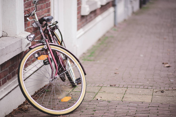 A view of a vintage bicycle against a brick wall - Photo, image