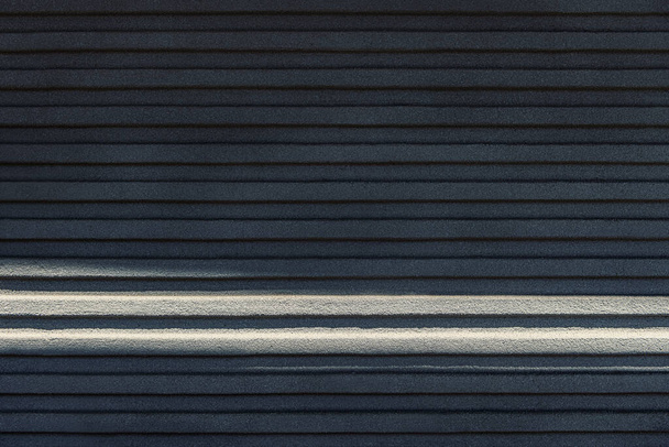 Bright sunlight falling on a gray striped surface - Foto, immagini
