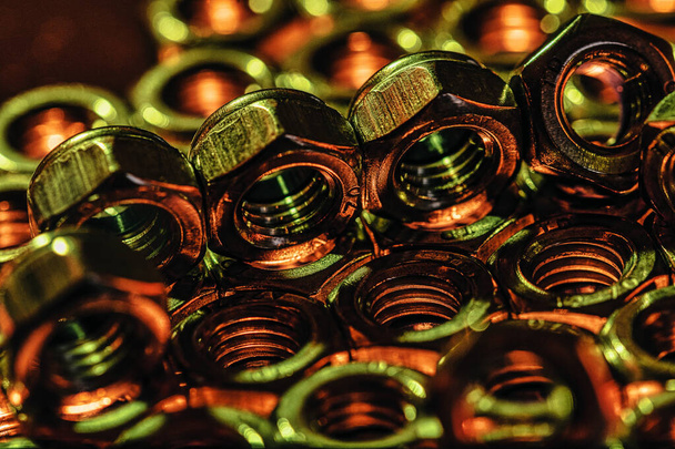 A closeup shot of metal screw nuts placed on the top of each other - Foto, Imagem