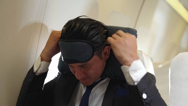 Sleepy businessman travel on a business trip by airplane - Photo, Image