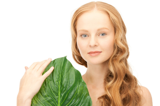 Woman with green leaf - Фото, изображение