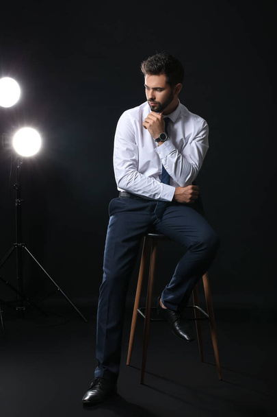 Handsome businessman with stylish wristwatch on dark background - Fotoğraf, Görsel