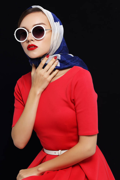 Young woman in retro style. Sunglasses and silk scarf. Sixties style fashion retro woman.  - Foto, immagini
