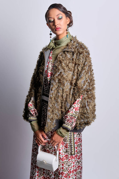 Fashion model in shaggy zipper coat and silk dress - Foto, afbeelding