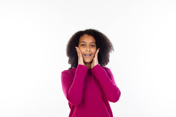 Beautiful teenager girl with pink sweater isolated on a white background - Foto, imagen