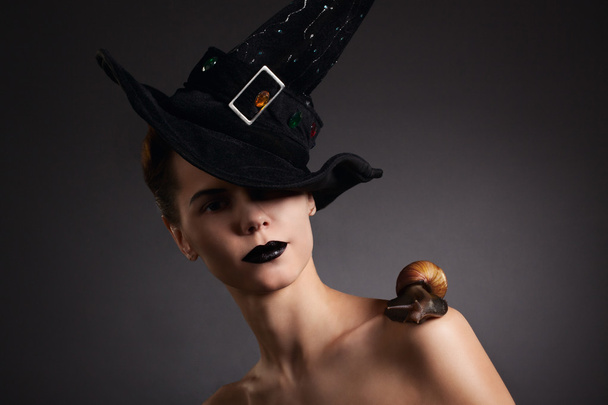 Woman with snail in hat. Fashion. Gothic - Φωτογραφία, εικόνα