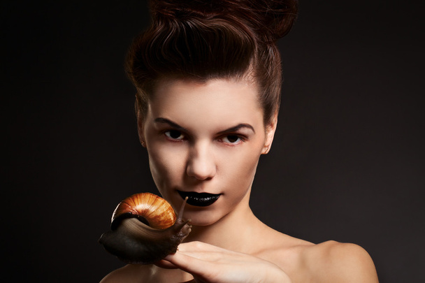 Portrait of a woman with snail. Fashion. Gothic - Valokuva, kuva