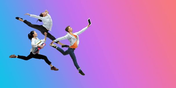Happy office workers jumping and dancing in casual clothes or suit on gradient neon fluid background. Flyer with copyspace - Foto, Imagen