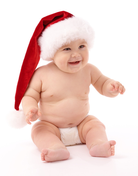 Little child wearing red Christmas cap - Fotó, kép