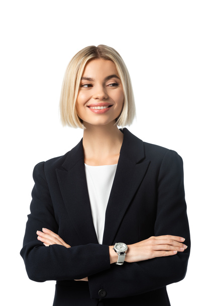 happy businesswoman with crossed arms smiling while looking away isolated on white - Valokuva, kuva
