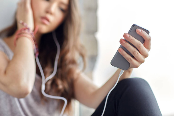 teenage girl with smartphone and earphones - Foto, Imagem