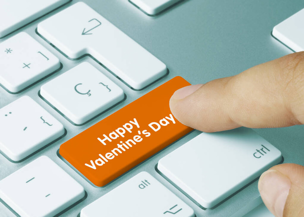 Happy Valentines Day Written on Orange Kery or Metallic Keyboard. Finger pressing key. - Photo, Image