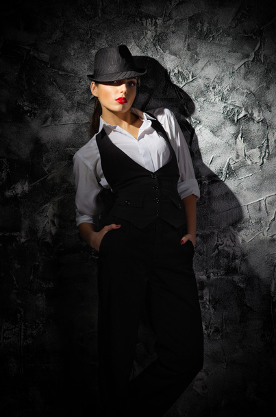 Woman with hat on grey wall - Fotografie, Obrázek