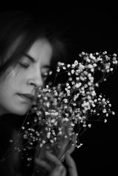 People and dry plants. Minimalistic black and white portrait of a girl and a herbarium. Space for text - Photo, image