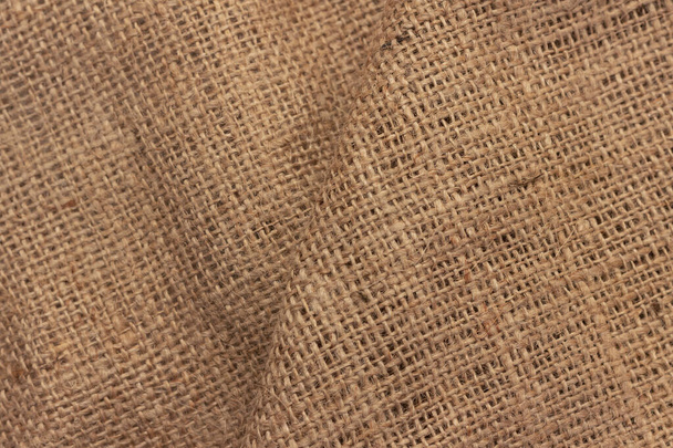 The texture of an uneven crumpled, roughly woven burlap. - Photo, Image