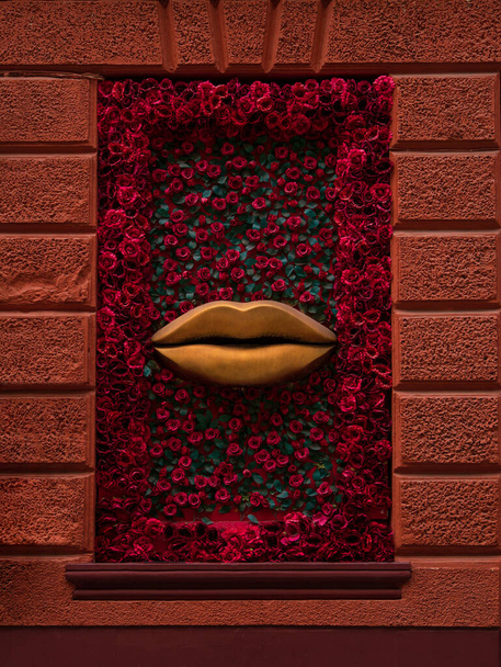 Creative fashionable shop window sexy red lips and red roses. Stylish store display with flowers decorations and golden mouth. Marketing advertisement retail boutique exterior design. Shopping concept - Photo, Image