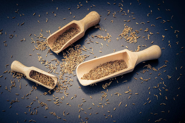 Caraway seeds on olive wood - Фото, изображение