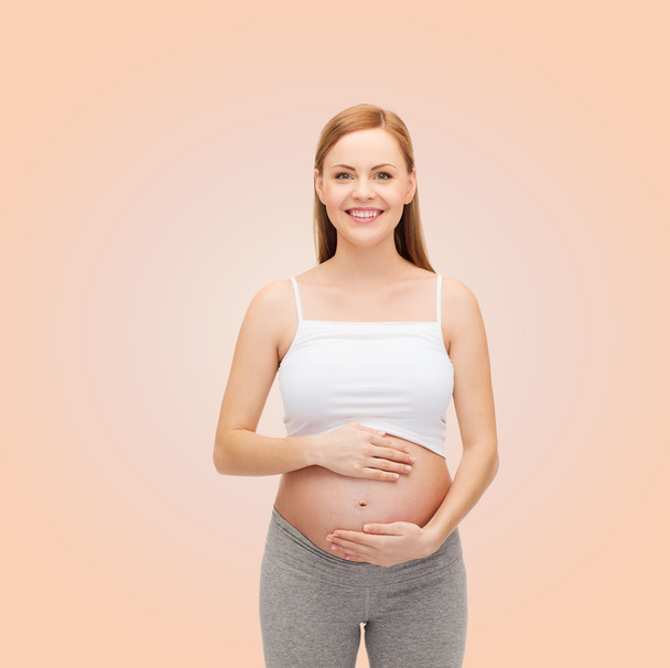 Happy future mother touching her belly - Photo, Image