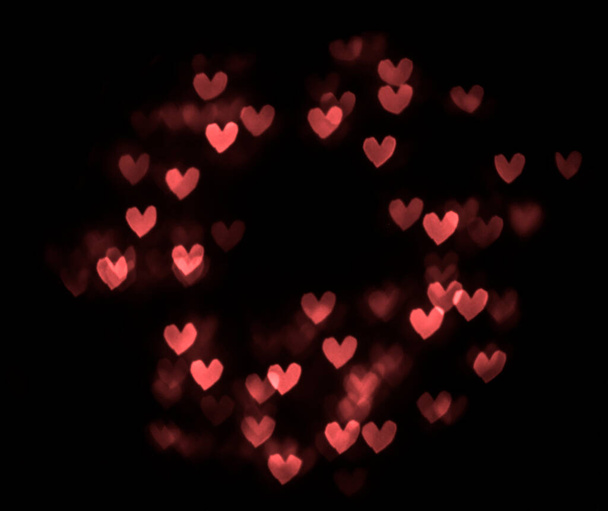 hearts bokeh isolated on black background. 14th february. happy Valentines day. round frame. - Photo, image