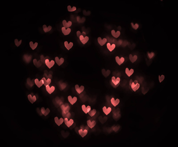 hearts bokeh isolated on black background. 14th february. happy Valentines day. round frame. - Zdjęcie, obraz