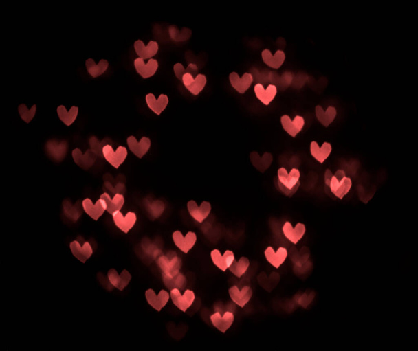 hearts bokeh isolated on black background. 14th february. happy Valentines day. round frame. - Фото, зображення