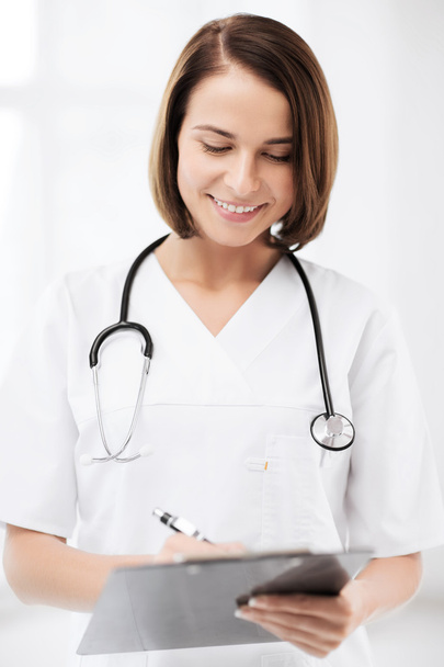 Doctor with stethoscope writing prescription - Фото, изображение