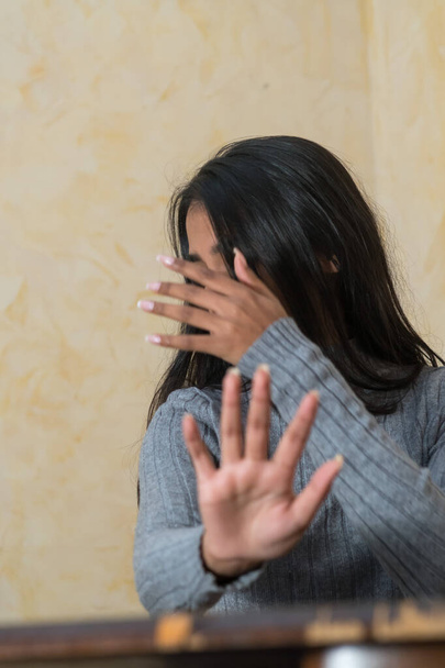 Self defence, young Indian woman covering her face with hand - Photo, Image