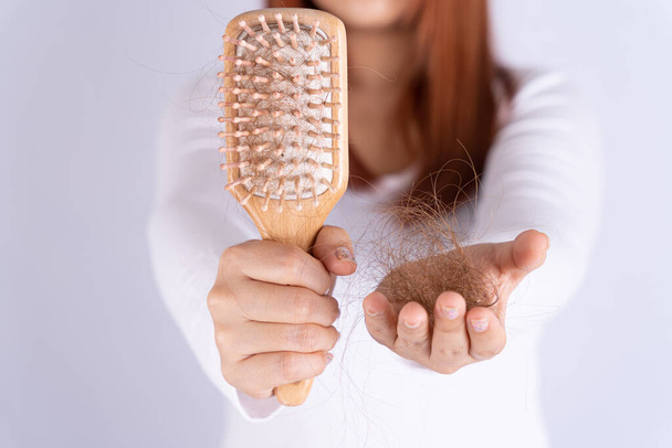 Hair fall problem, closeup hand holding comb and problem hair. Healthcare medical or daily life concept. - Φωτογραφία, εικόνα