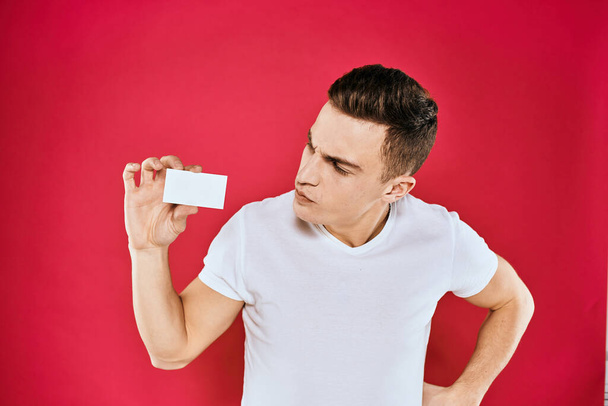 man holding business card manager Coffee Space white t-shirt red isolated background - Foto, imagen