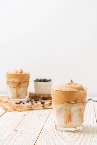 Dalgona coffee. Iced fluffy creamy whipped trend drink with coffee foam and milk. Trendy drink during Covid-19 city lock down and self quarantine, stay at home concept. - Фото, зображення