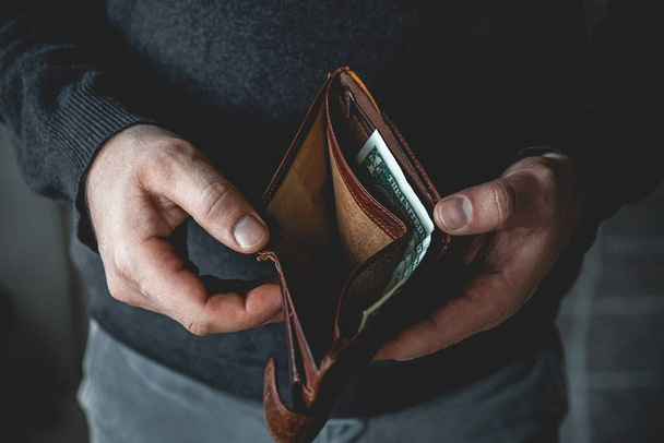 An Empty wallet in the hands of a young man - Fotoğraf, Görsel