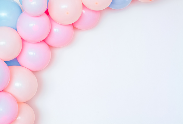 Colorful and joyful set of birthday balloons on a white wall. - Fotoğraf, Görsel