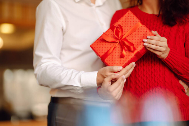 Exchange of gifts.  Young couple in love offering gift to each other for valentine day or birthday. Romantic day. Winter holidays. - Φωτογραφία, εικόνα