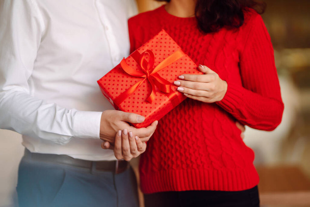 Exchange of gifts.  Young couple in love offering gift to each other for valentine day or birthday. Romantic day. Winter holidays. - Φωτογραφία, εικόνα