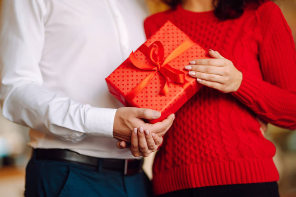 Exchange of gifts.  Young couple in love offering gift to each other for valentine day or birthday. Romantic day. Winter holidays. - Photo, image