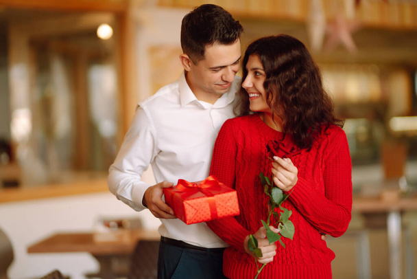 Exchange of gifts.  Young couple in love offering gift to each other for valentine day or birthday. Romantic day. Winter holidays. - Fotografie, Obrázek