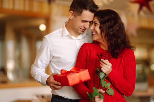 Exchange of gifts.  Young couple in love offering gift to each other for valentine day or birthday. Romantic day. Winter holidays. - Photo, Image