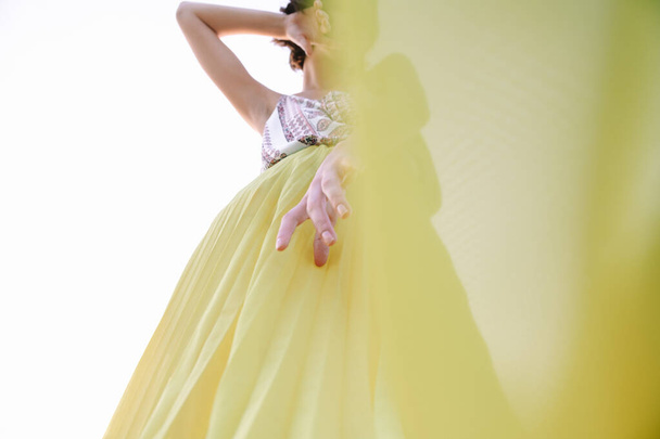 woman in yellow skirt dancing and posing - Foto, Imagen