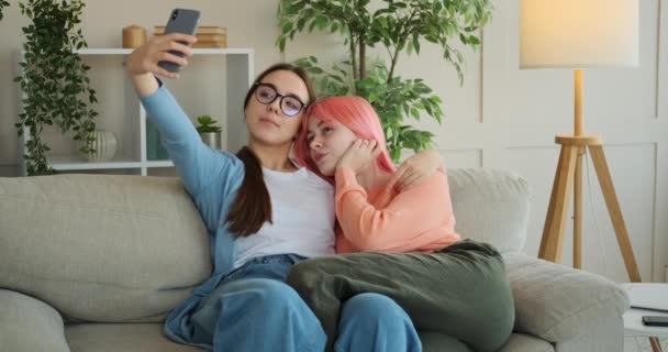 Lesbian couple having fun while taking selfie - Filmati, video
