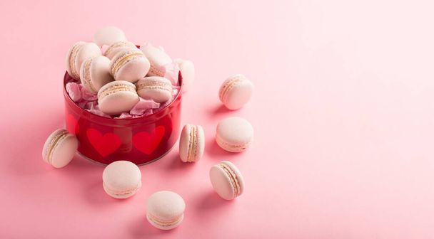Rose macaroons present in gift box on pink background, copy space. Selective focus. Festive holiday greeting card for Valentines, Birthday, Woman, Mothers Day. - Foto, Imagem