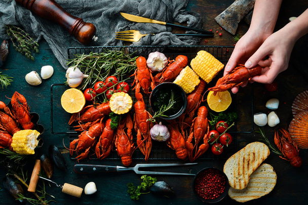 Barbecue. Red crayfish with grilled vegetables and sauce on a stone kitchen table. Seafood. Top view. Flat lay. - Photo, Image