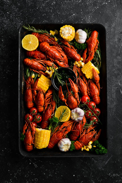 Barbecue. Red crayfish with grilled vegetables and sauce on a stone kitchen table. Seafood. Top view. Flat lay. - Zdjęcie, obraz