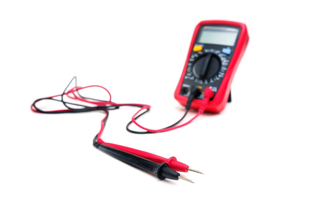 Red digital multimeter with probes on white background - Multimeter is an electronic measuring instrument for voltage, amper, resistance - Photo, Image