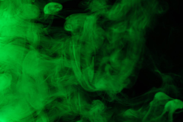Green steam on a black background. Copy space. - Photo, image