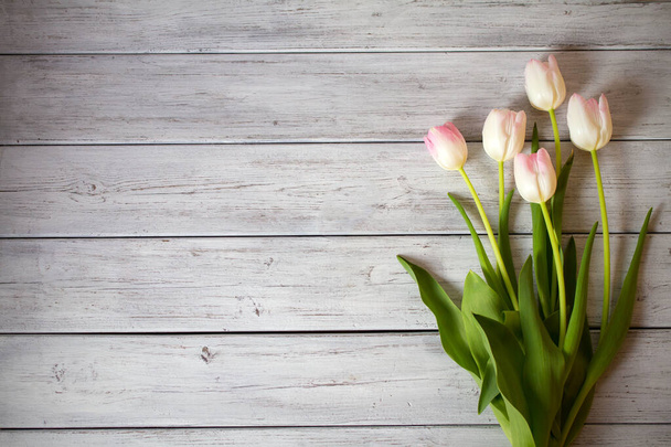 Spring tulip flower composition on wooden background. Overhead view - Foto, Bild