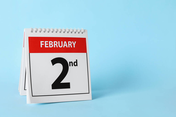 Calendar with date February 2nd on light blue background, space for text. Groundhog day - Фото, зображення